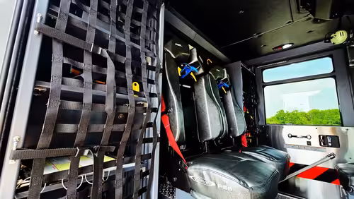 Crew seating area view showing SCBA seats and cargo net storage