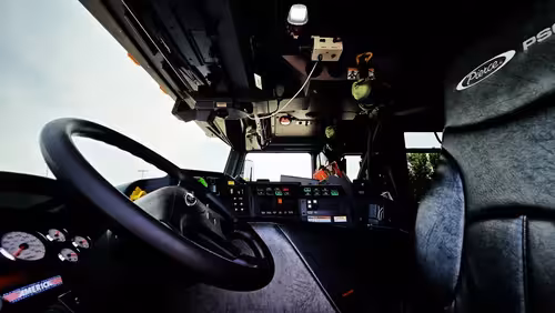 Cab interior side view showing center console and front passenger area