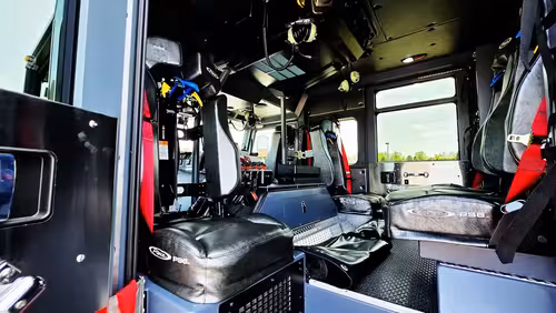 Cab rear-facing view showing center console and crew seat area