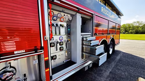 Open side compartment showing pump controls and connection panel