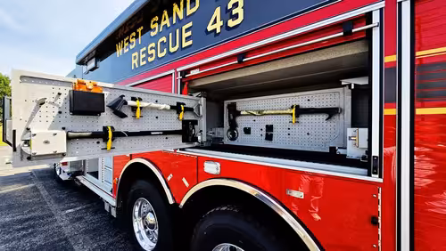 Open side compartment with pull-out tray showing tool bins and equipment