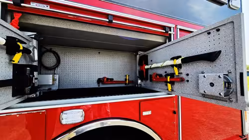 Open side compartment showing shelving and mounted gear space