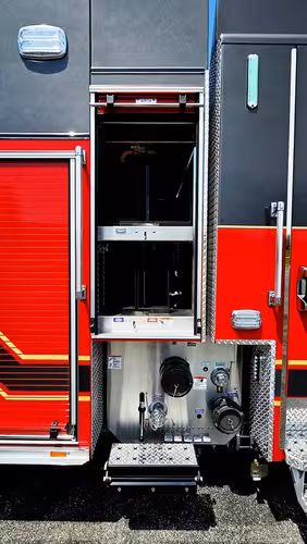 Open rear-side compartment showing stacked equipment bins