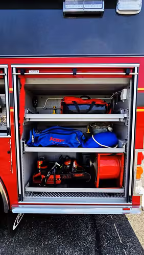 Open side compartment showing lower tray with rescue gear