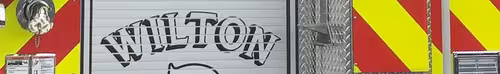 Narrow crop of the rear roll-up door area with stylized unit lettering over the chevron background.