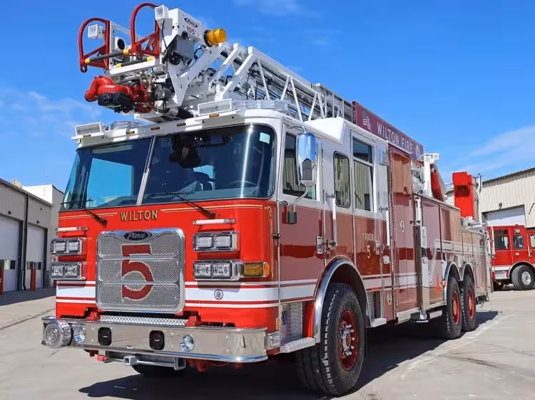 Tower ladder truck front-left exterior view showing cab and aerial sections