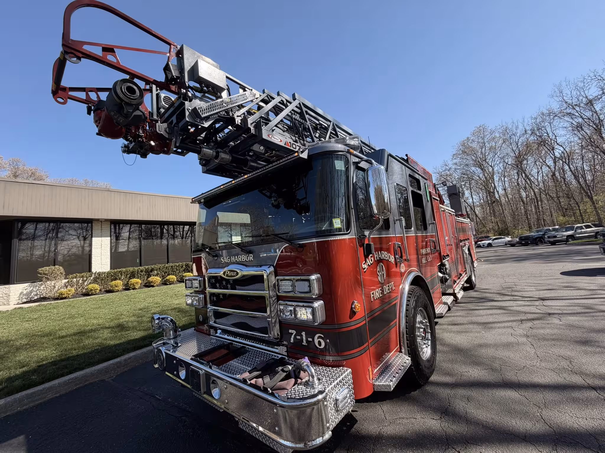 Pierce aerial ladder front view showing bumper, grille, and ladder bed