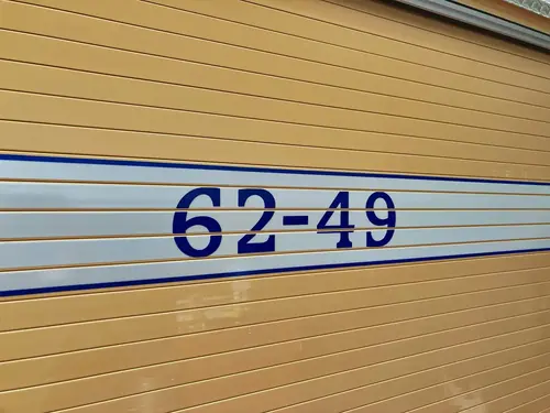 Roll-up compartment door close-up showing unit number lettering