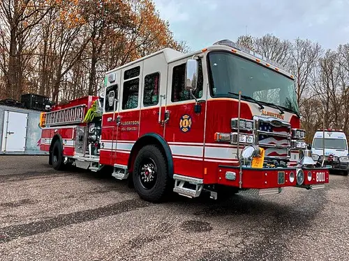 Pumper-tanker front-right exterior view showing bumper, cab, and side body compartments