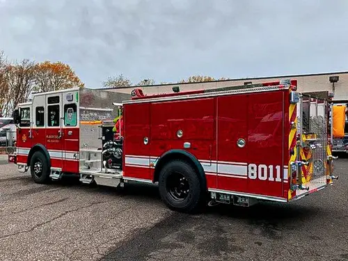 Rear-right exterior view showing rear step, chevrons, and tank body