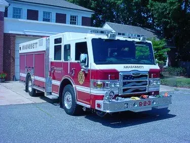 Pumper front-left exterior view showing enclosed cab and side compartments