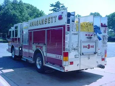 Rear-right exterior view showing hosebed side stack and rear wheel area