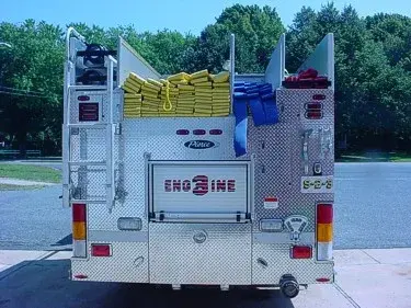 Rear view showing hose bundles in hosebed and rear warning lights