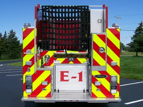 Rear view showing red-and-yellow chevrons and upper hosebed netting