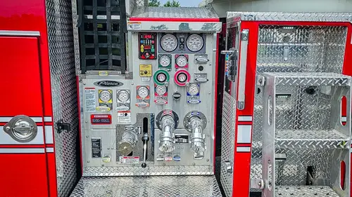 Pump panel close-up showing gauges, valves, and intake controls
