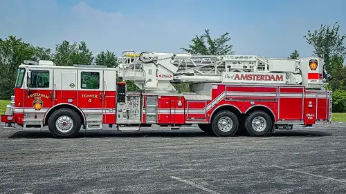 Driver-side full profile view showing tower ladder body and side compartments