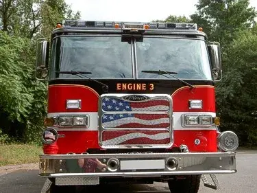 Front exterior view showing grille, bumper, and warning lights