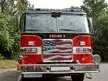Front exterior view showing grille, bumper, and warning lights