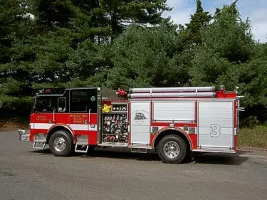 Driver-side profile view showing pump panel and side compartments