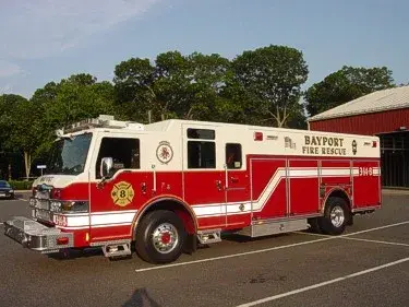 Front left side view showing cab doors, wheel area, and full rescue body profile.