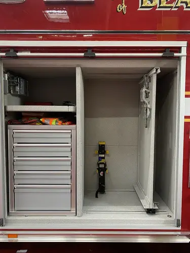 Open side compartment showing tall drawer stack and adjacent empty shelf bay