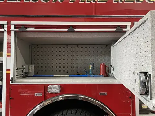 Open side compartment showing empty shelf bay with pegboard back panel