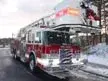 Tower ladder truck front-left exterior profile showing cab and aerial sections
