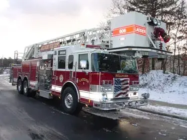 Front-left exterior profile showing tower ladder body and side compartments