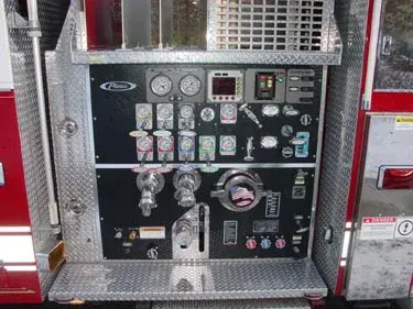 Pump panel close-up showing gauges, valves, and intake controls