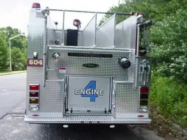 Straight rear view showing rear warning lights, rear panel fittings, and center rear compartment door.