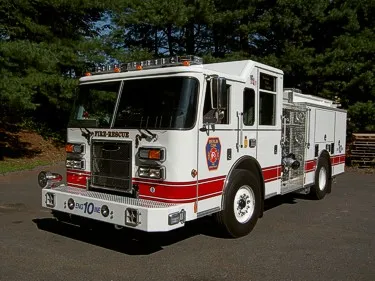 Pumper front-left exterior view showing enclosed cab and side compartments