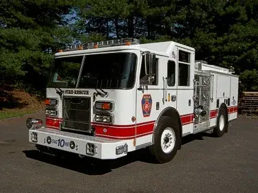 Pumper front-left exterior view showing enclosed cab and side compartments