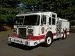 Pumper front-left exterior view showing enclosed cab and side compartments