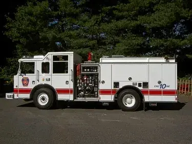Driver-side profile with open pump panel showing gauges and controls
