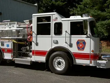 Passenger-side cab close-up showing door logo and rear wheel area