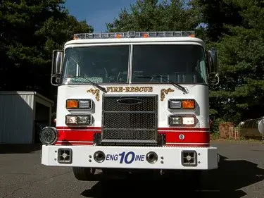 Front exterior view showing grille, bumper, and warning lights