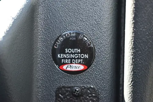 Cab interior trim close-up showing circular company badge insert