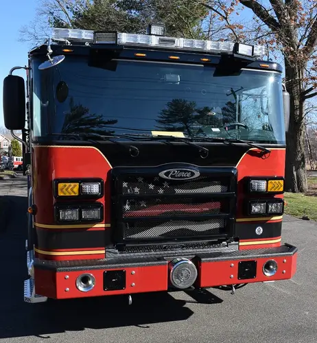 Head-on front view showing grille, bumper intake, and warning lights