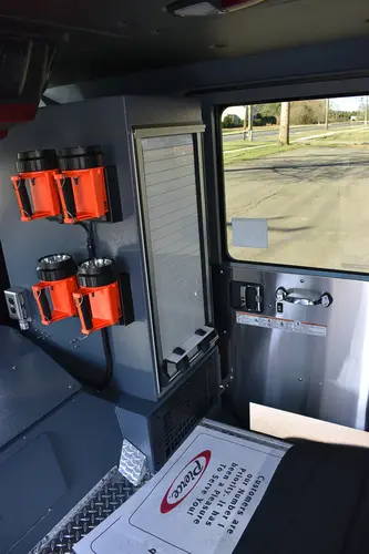 Cab interior side view showing mounted controls and side console