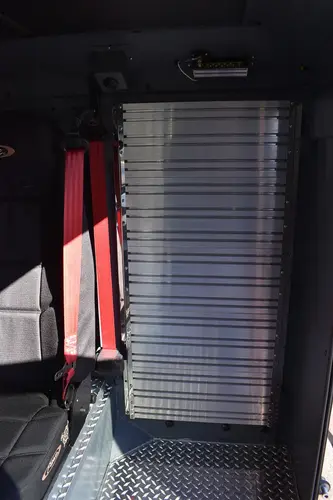 Cab interior rear view showing folded seat section and aisle space