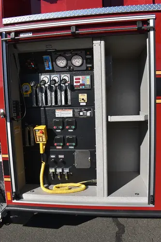 Pump panel close-up showing gauges, valves, and intake controls