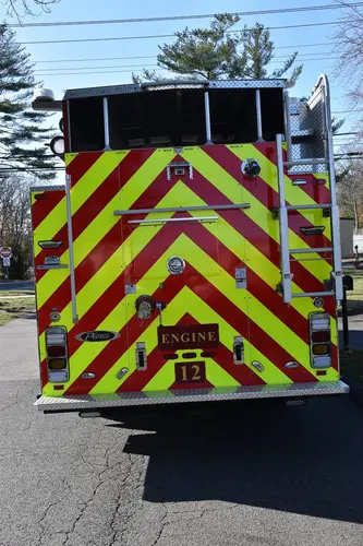 Rear view showing red-and-yellow chevrons and ladder access section