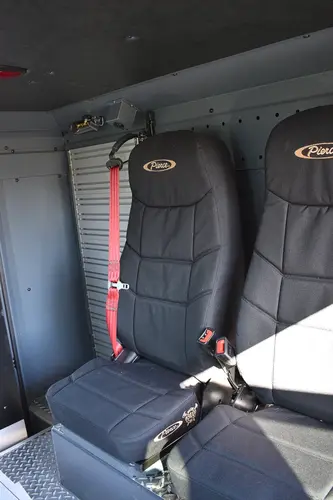 Cab interior close-up showing rear seat cushions and restraint straps