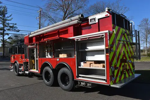 Driver-side profile with open rear compartment showing storage bay