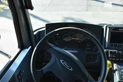 Driver cockpit view showing steering wheel, dashboard, and center controls