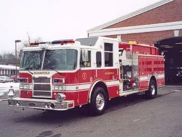 Pumper front-left exterior view showing grille, bumper, and open pump panel area
