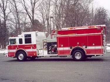 Driver-side profile view showing side compartments and midship pump controls