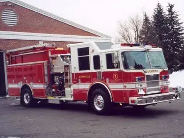 Front-right exterior view showing cab, side body, and open pump panel section