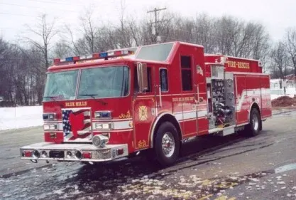 Rescue pumper front-left exterior view in snow showing enclosed cab and side compartments