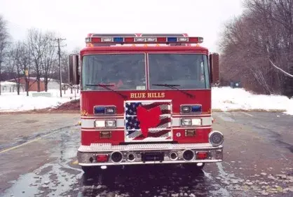 Front exterior view showing grille, bumper, and warning lights
